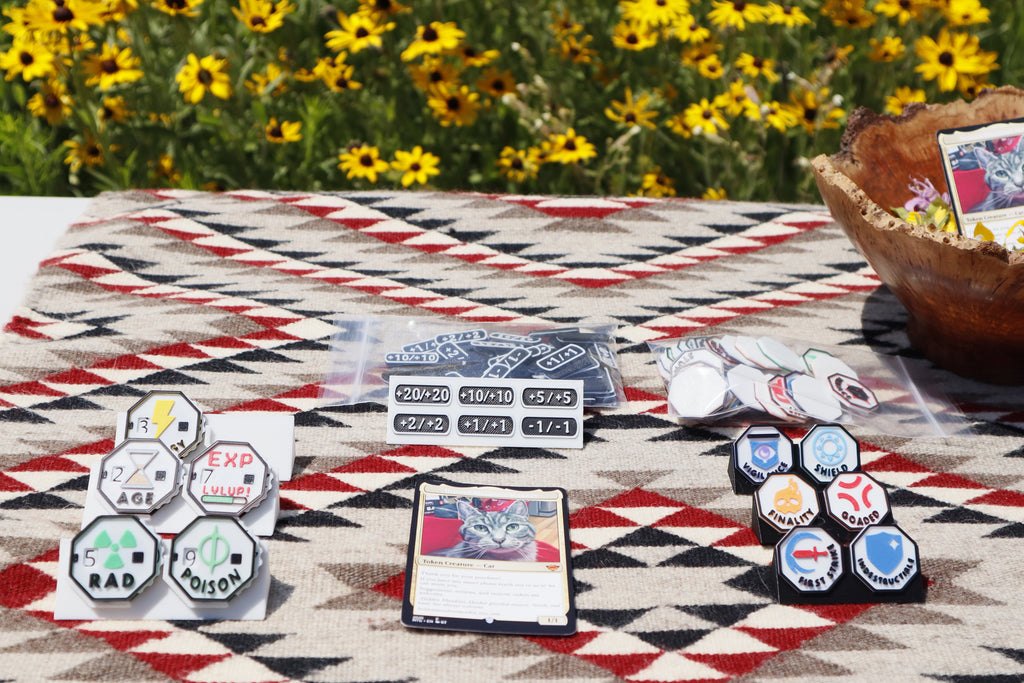 Picture of the essential bundle in a prairie. Essential bundle includes pack of 1/1 counters, keyword counters and variety pack of effect dials.