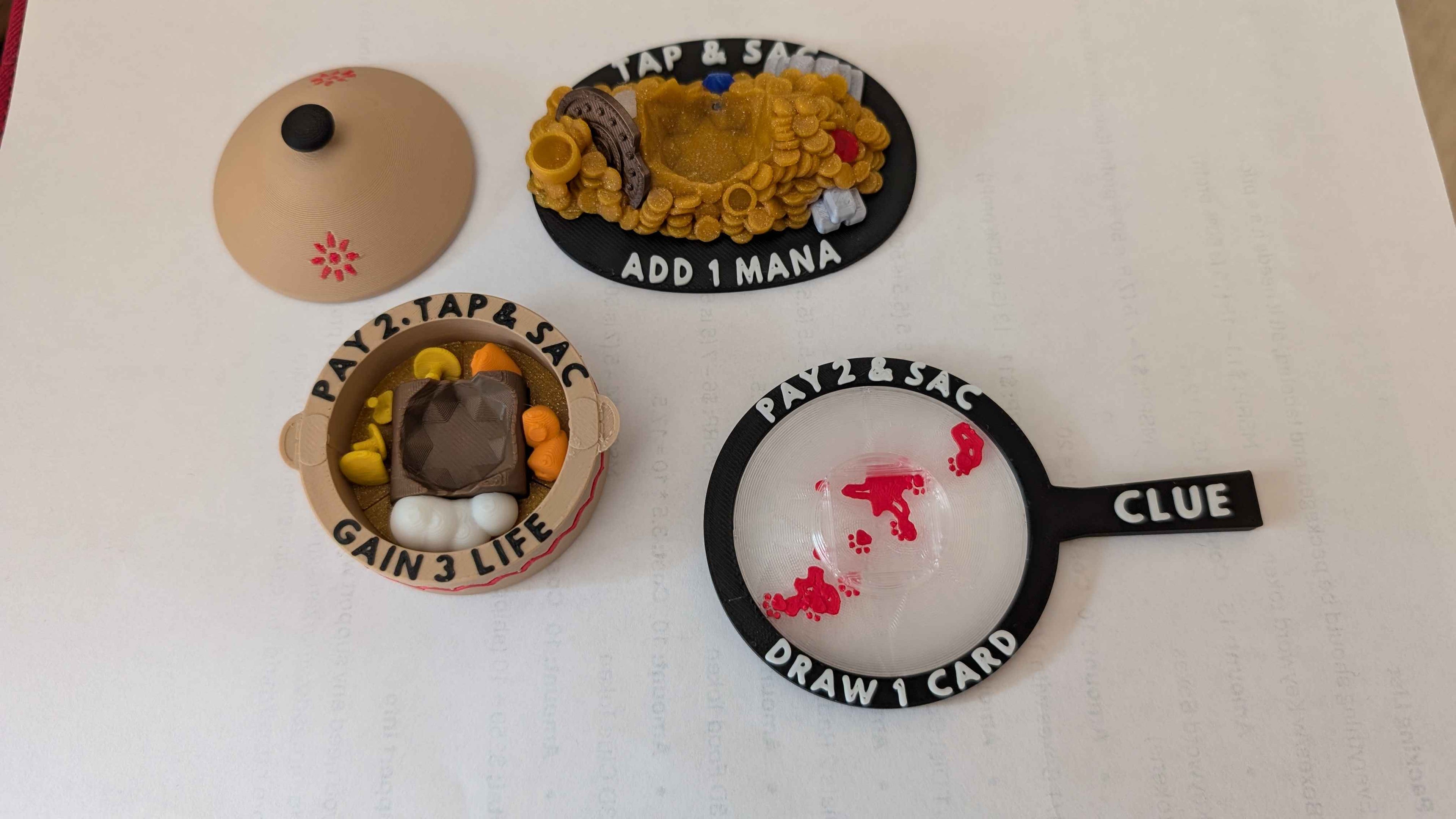 3 MTG Artifact Tokens: with instructions. Clue Token in the shape of a magnifying glass with a D6 slot in the middle. Treasure token in the shape of a treasure pile with other valuables with a d20 slot in the middle. Food token in the shape of a cooking stew with a removable D20 slot.